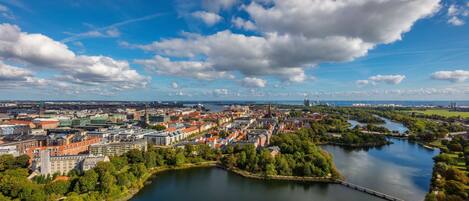 An aerial view of a city with a river, buildings, and a bridge.