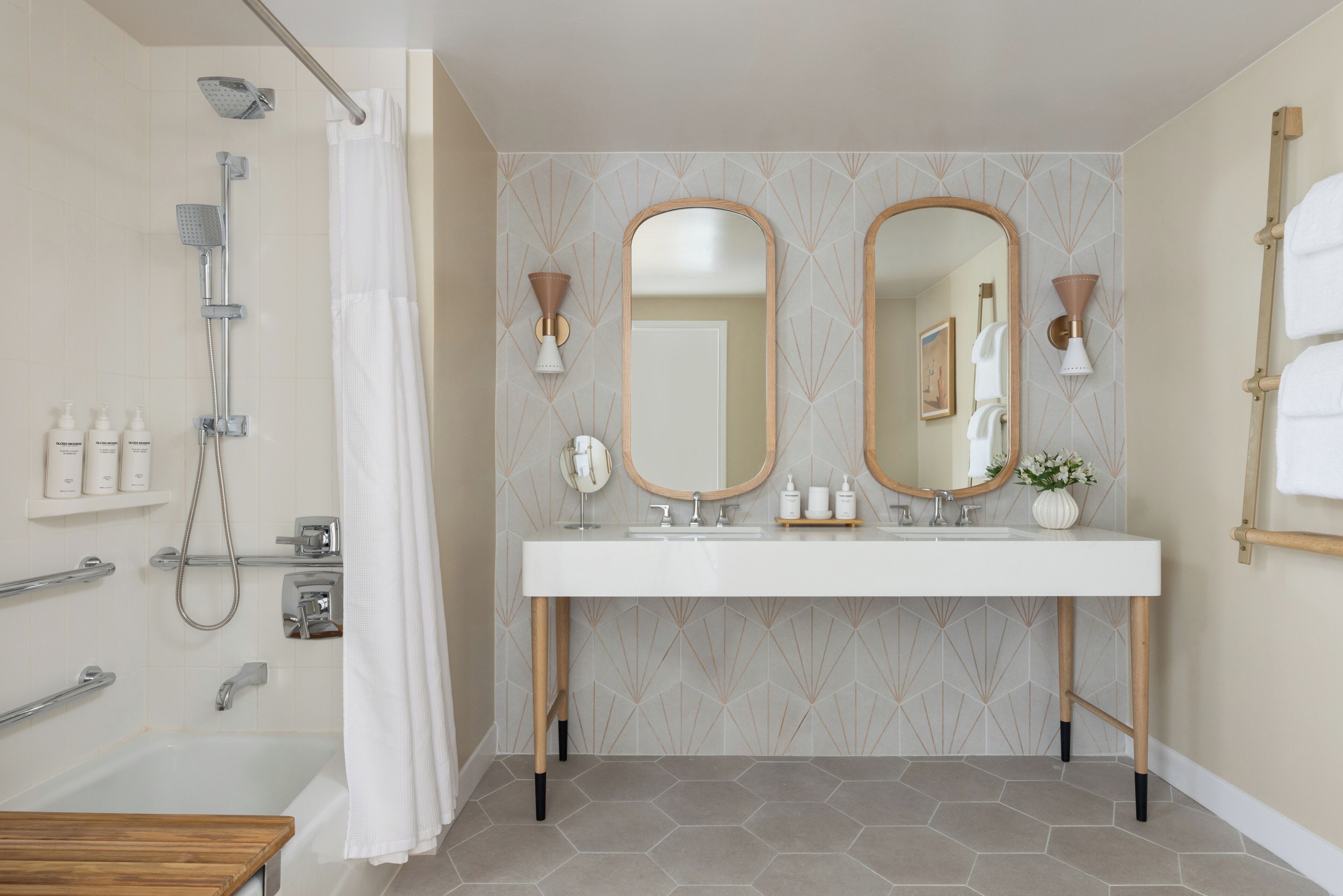 A bathroom with a shower, a bathtub, a vanity with a mirror, and a sink.