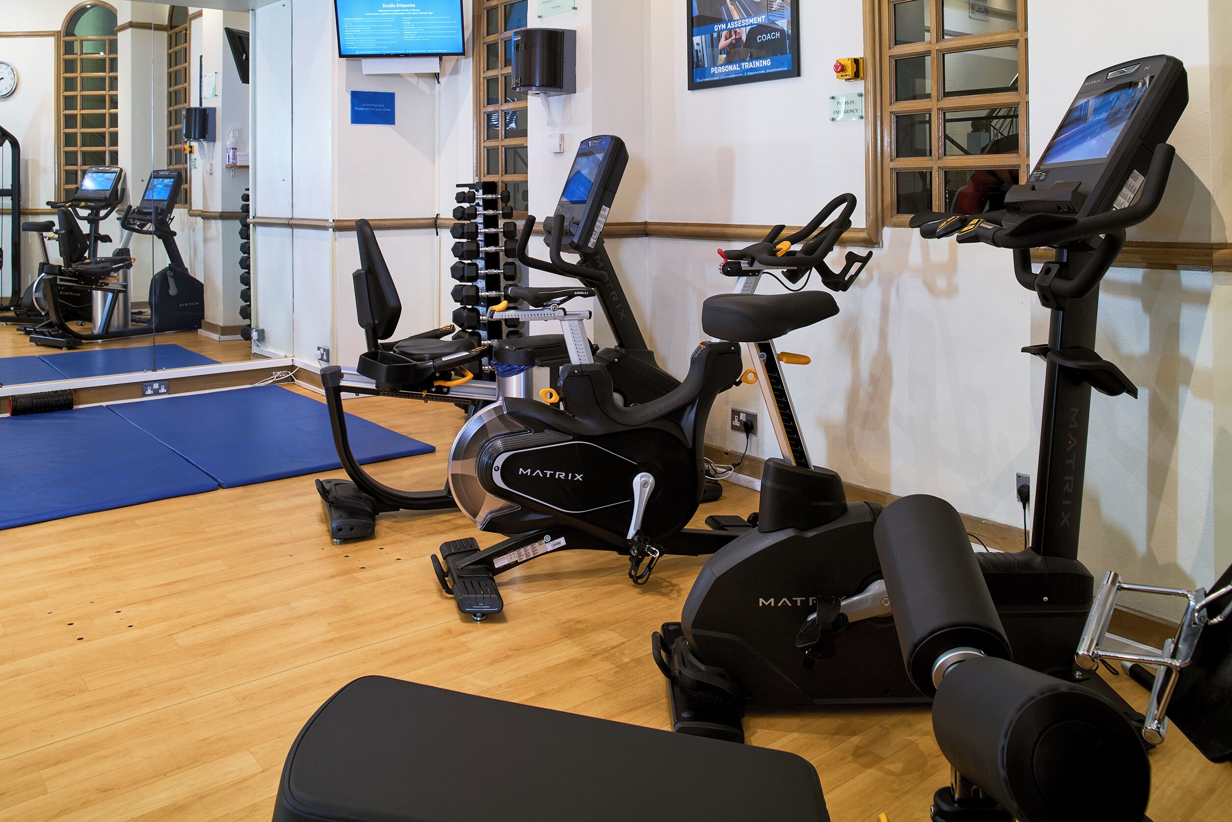 A gym with stationary bikes, treadmills, and weight machines.