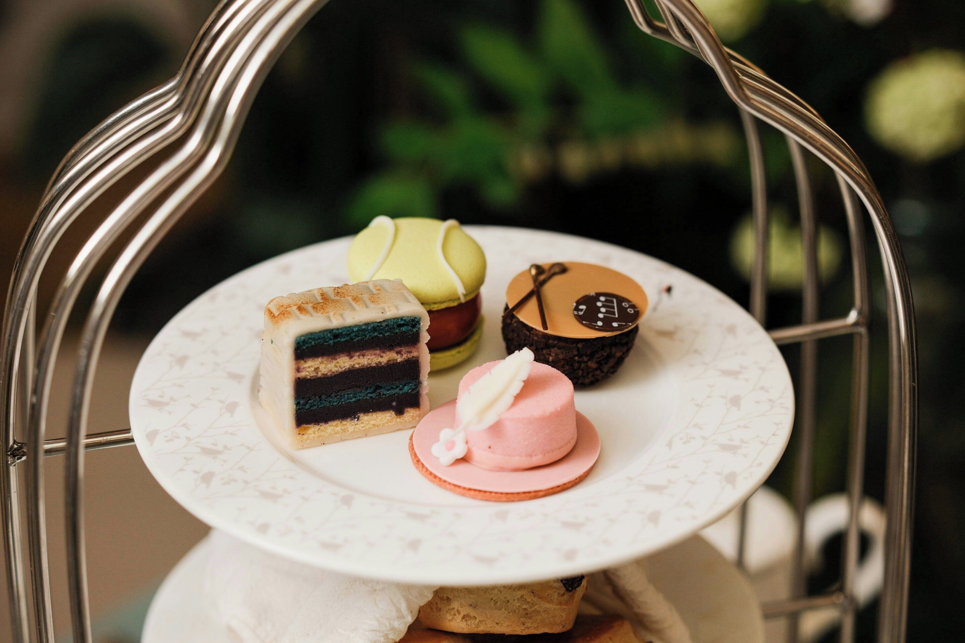 A tiered serving tray with various desserts.