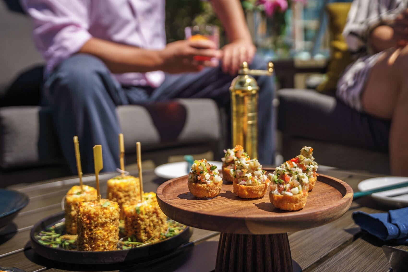 A table with food items, including appetizers and a drink.