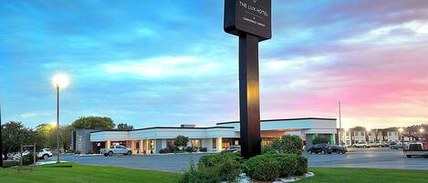 A hotel sign with "The Lux Hotel" and "Conference Center" written on it.