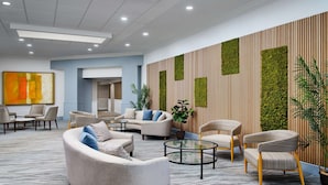 A modern lobby with sofas, armchairs, and a coffee table. - DoubleTree by Hilton Hotel Rocky Mount (Rocky Mount)