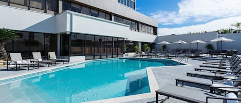 Outdoor pool, open 7 AM to 10 PM, pool umbrellas, pool loungers