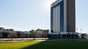 A tall, modern hotel with a prominent Marriott logo.