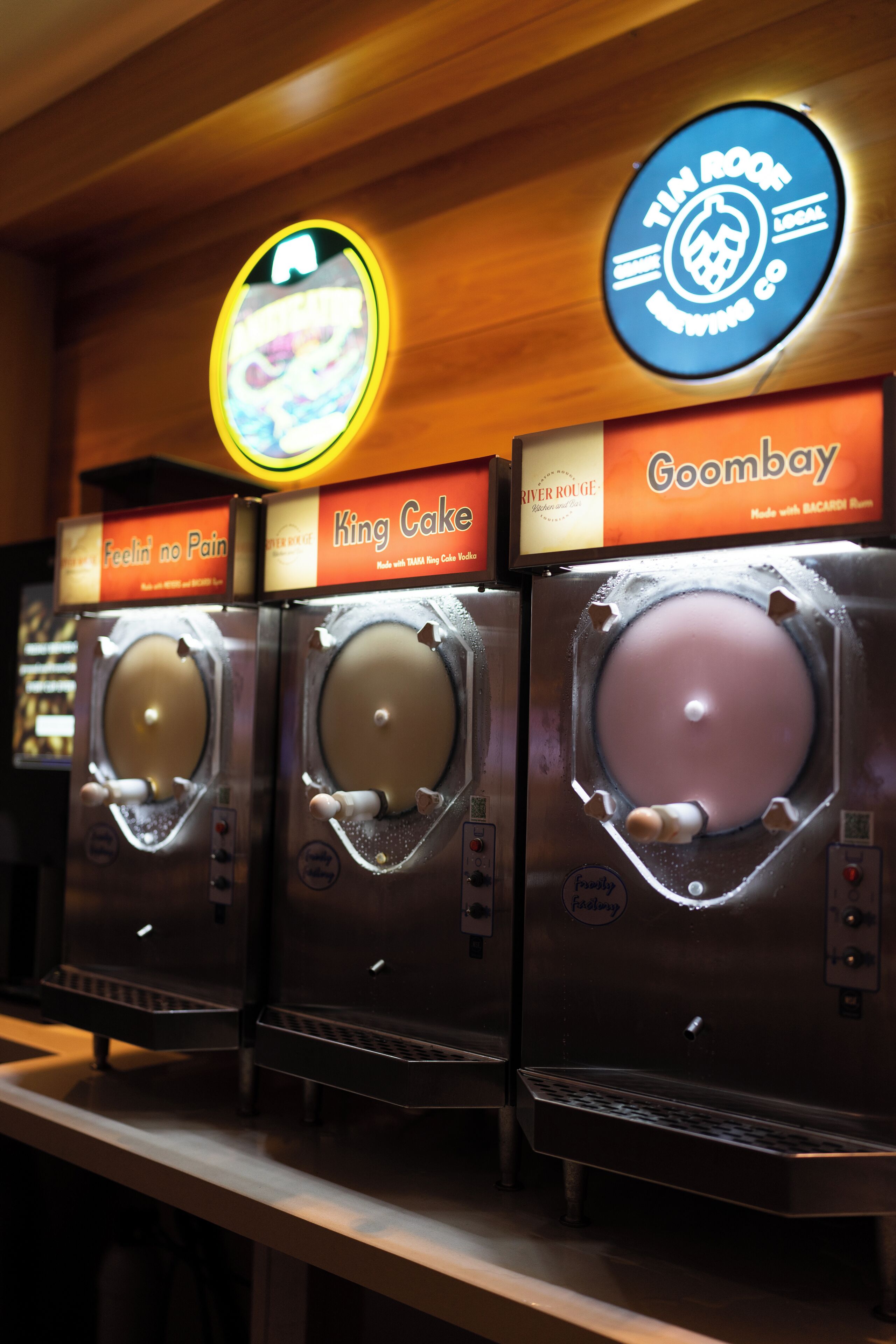 Three ice cream machines labeled 'King Cake' and 'Goombay' with a sign above them.