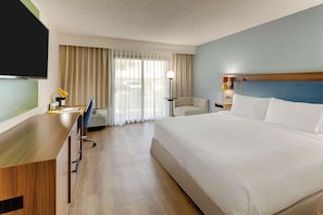 Premium bedding, desk, laptop workspace, blackout drapes