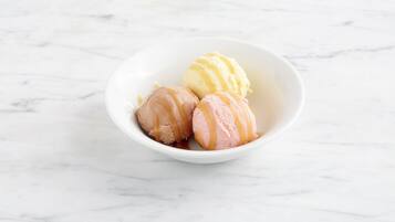 A bowl of ice cream with three scoops.