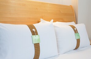 A bed with two pillows and a headboard.
