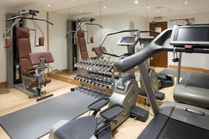A gym with various exercise equipment including a treadmill, weight machines, and a rowing machine. - Holiday Inn Dover by IHG (Dover)