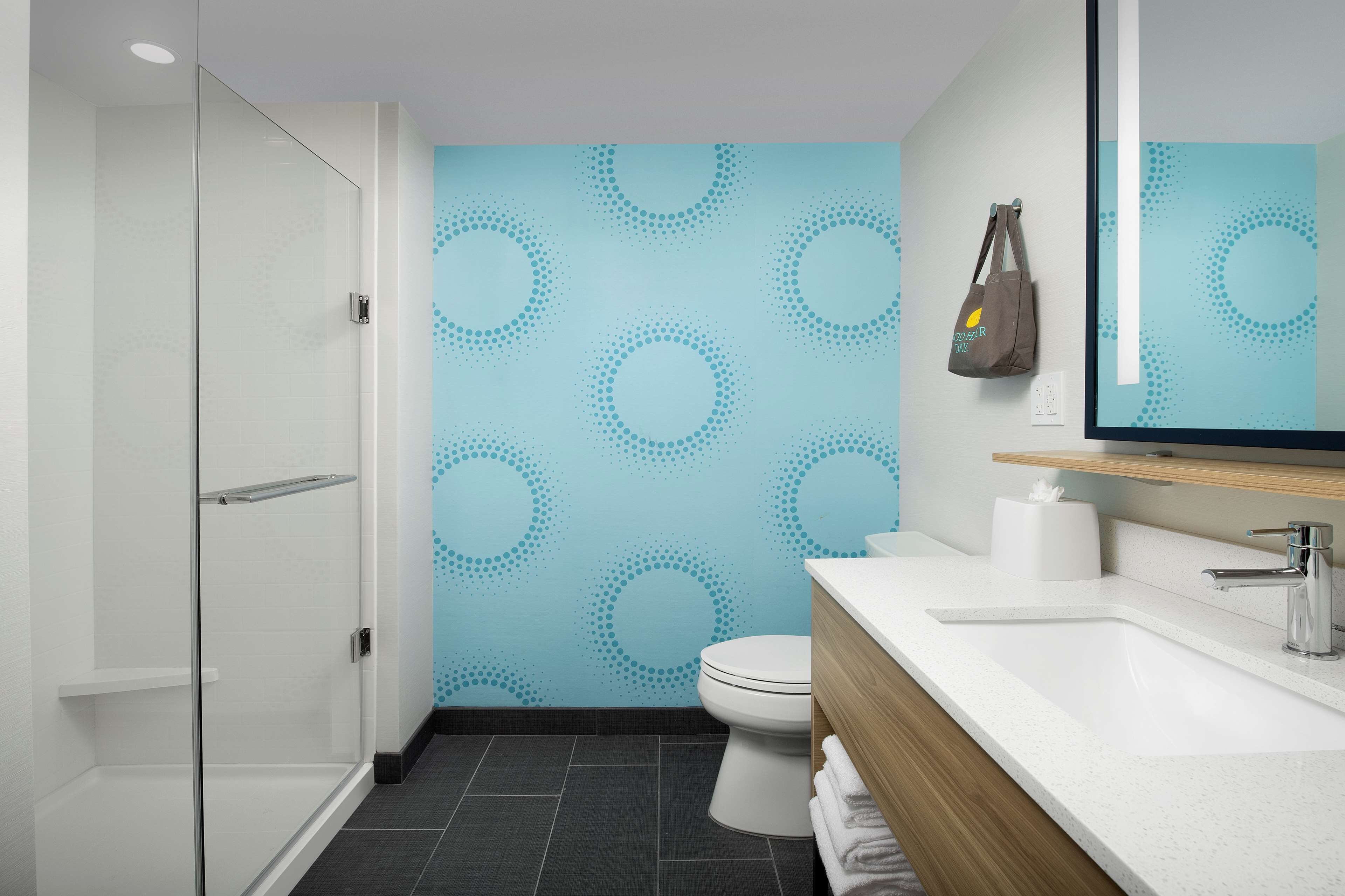 rainfall showerhead, eco-friendly toiletries, hair dryer, towels