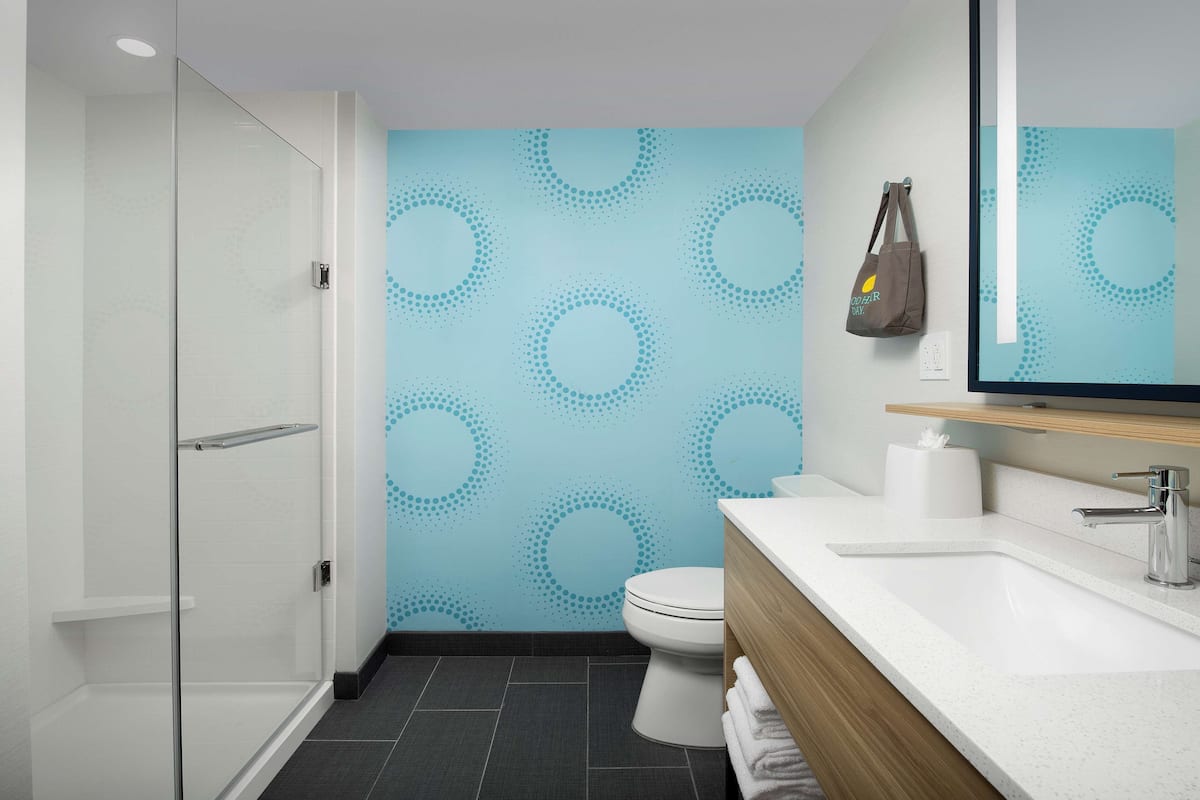 rainfall showerhead, eco-friendly toiletries, hair dryer, towels