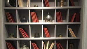 A bookshelf with multiple shelves, each containing books and decorative items.