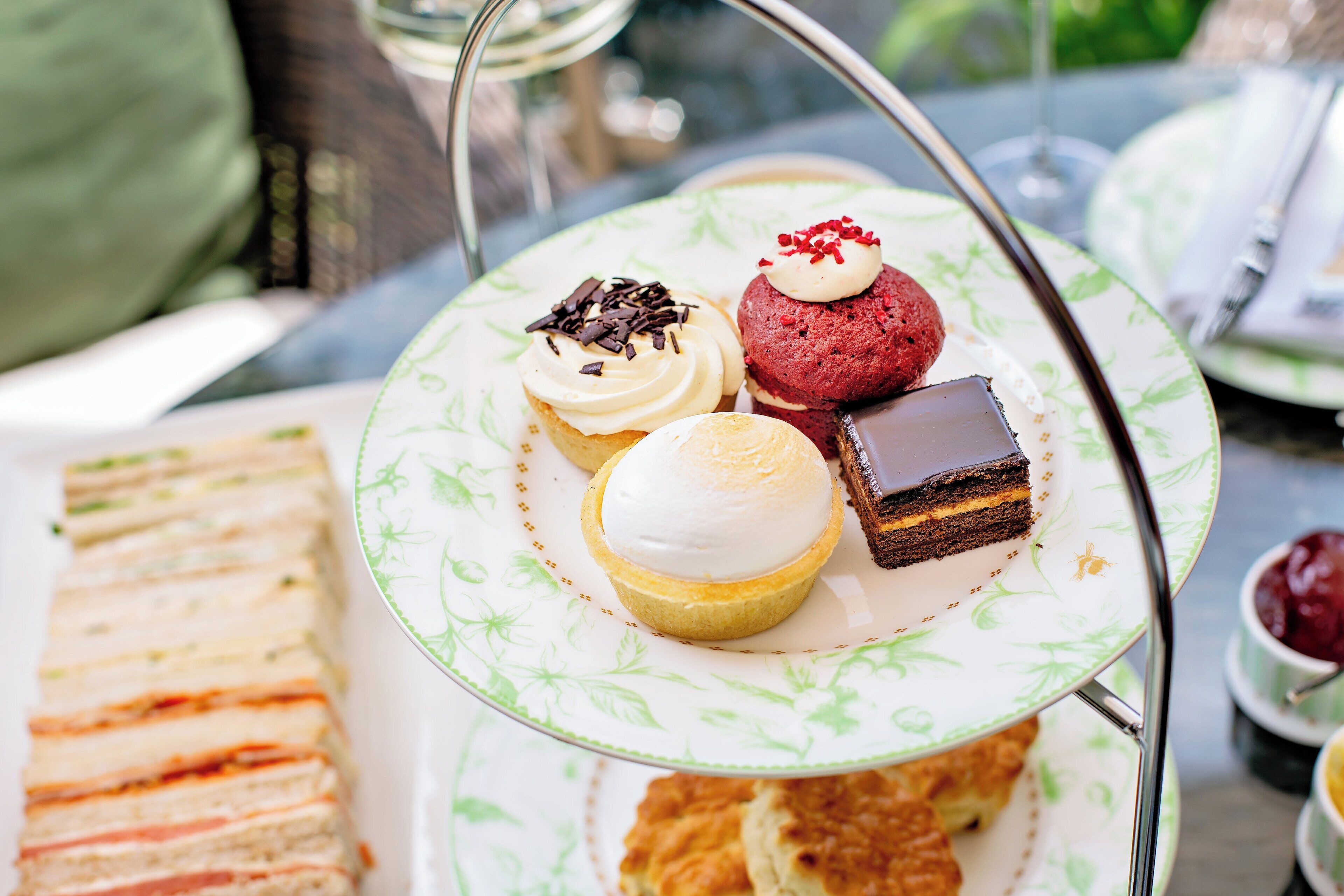 A tiered tea service with various pastries and sandwiches.