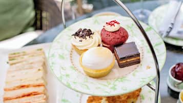 A tiered tea service with various pastries and sandwiches.