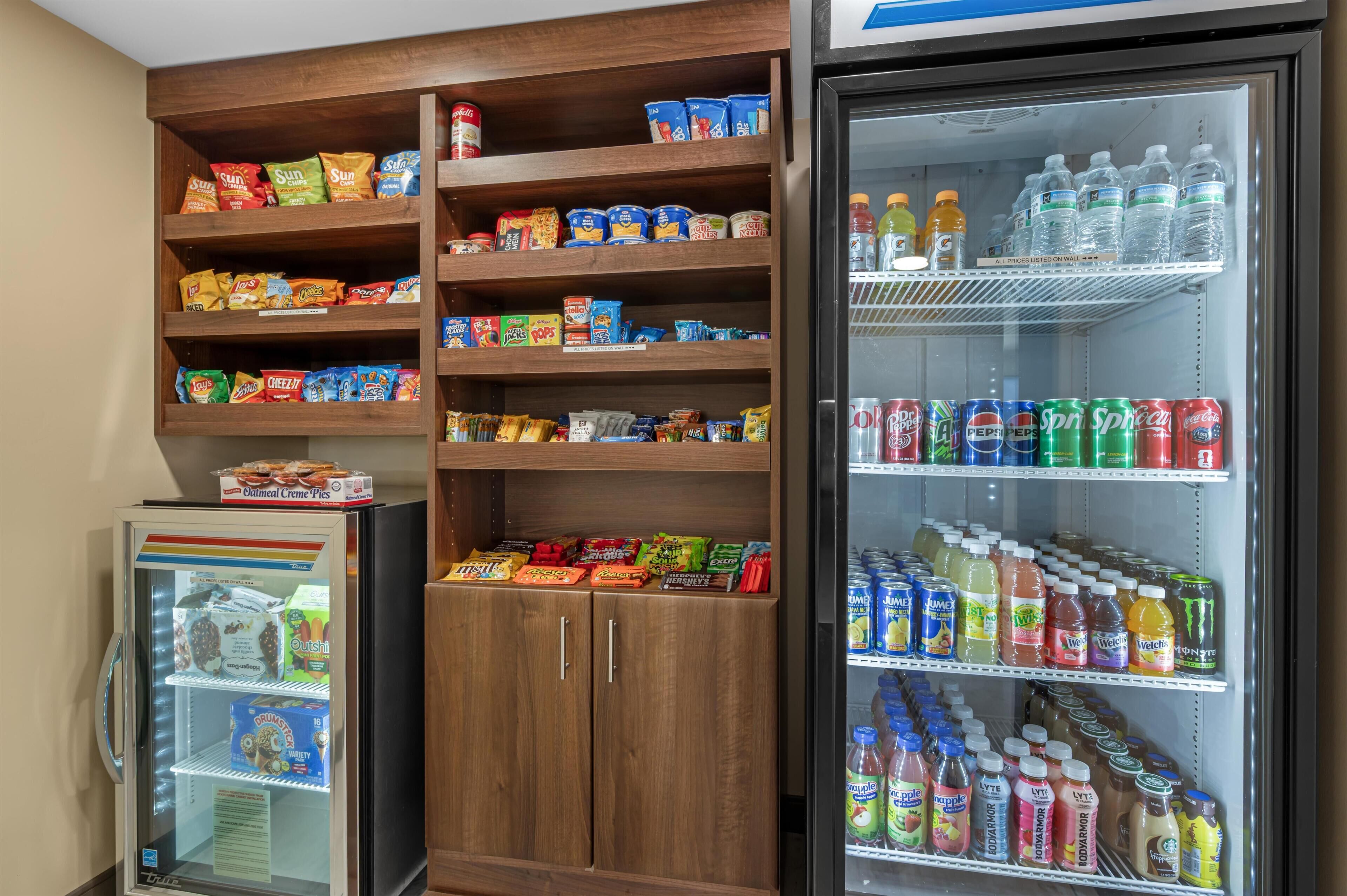 A refrigerated display case with snacks and beverages.