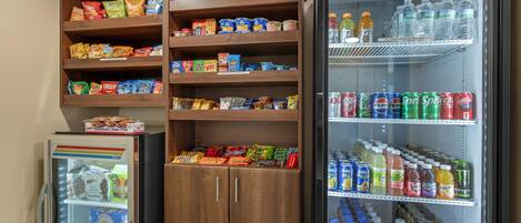 A refrigerated display case with snacks and beverages.