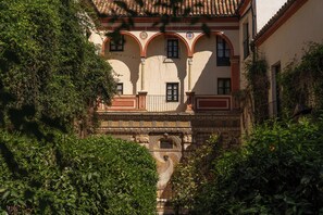 A building with arches, a tiled roof, and a stone facade.