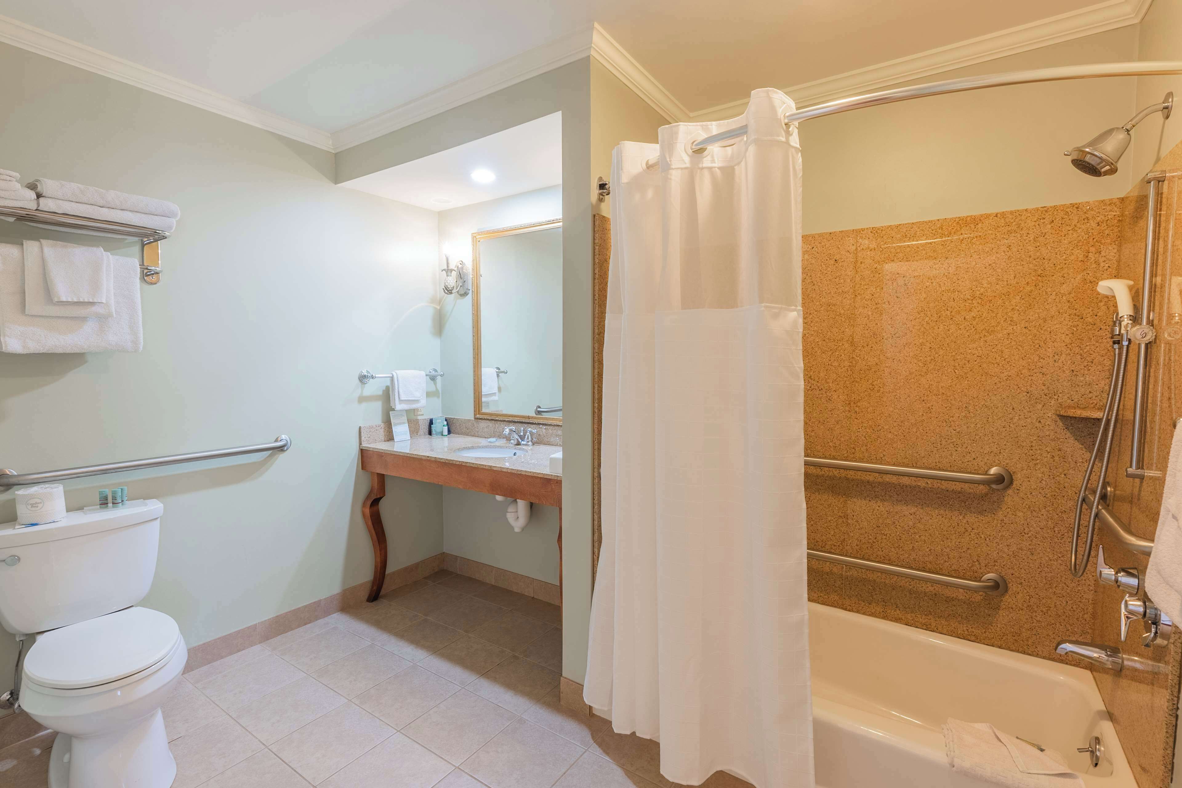 A bathroom with a toilet, sink, and bathtub.