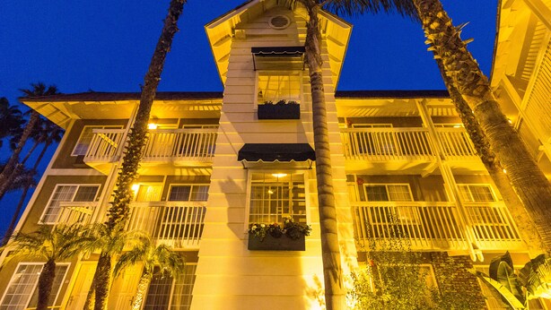 A multi-story hotel with balconies, large windows, and a central entrance. - Ramada by Wyndham Costa Mesa/Newport Beach (Costa Mesa)