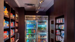 A vending machine area with snack and drink options, including chips, sodas, and bottled water. - Sonesta Select Atlanta Norcross (Norcross)