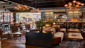 A modern bar area with seating, bar counter, and various bar tools. - High Country Motor Lodge – Near NAU/Downtown (Flagstaff)
