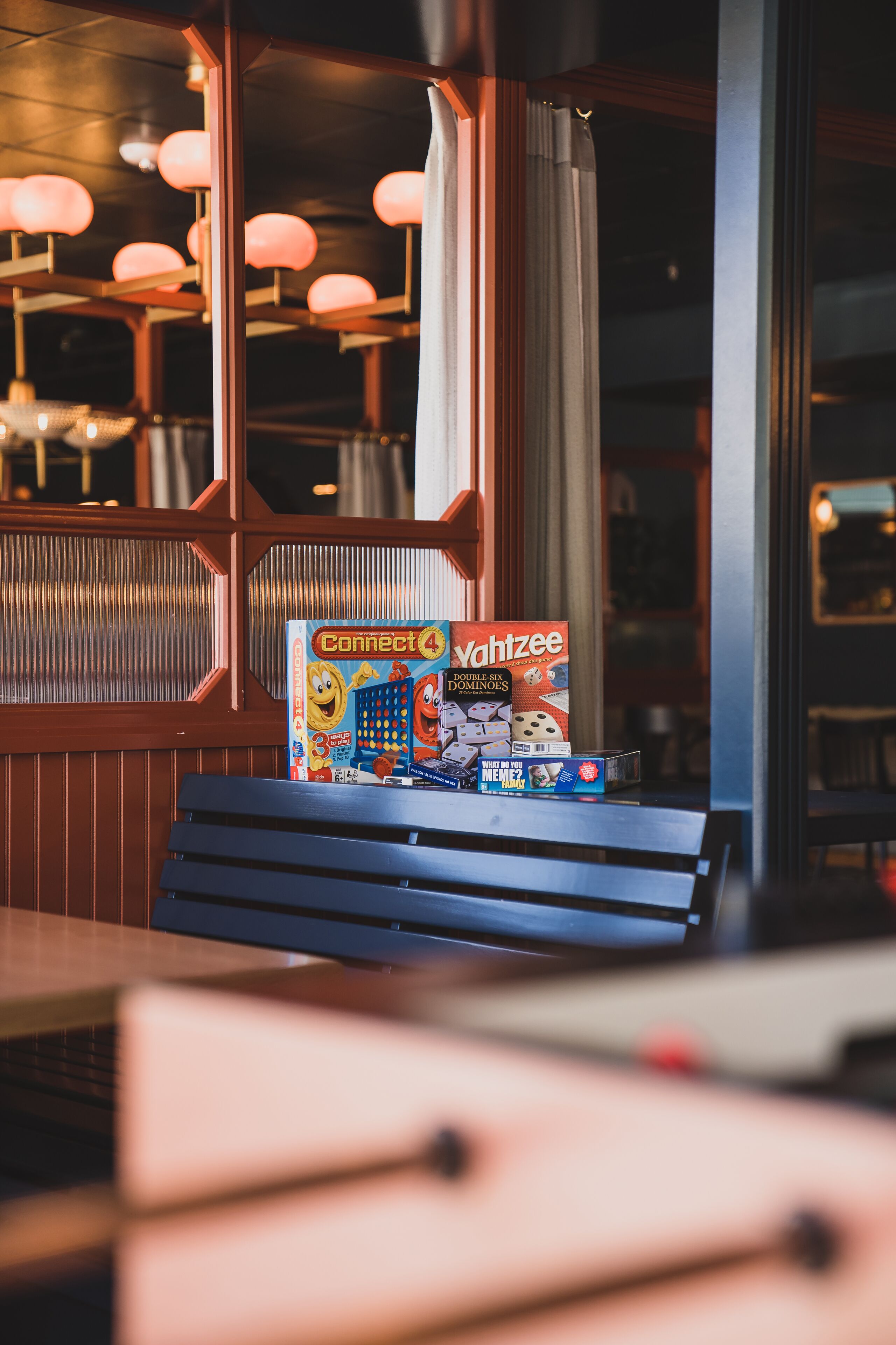 A table with a board game and a box of dominoes.