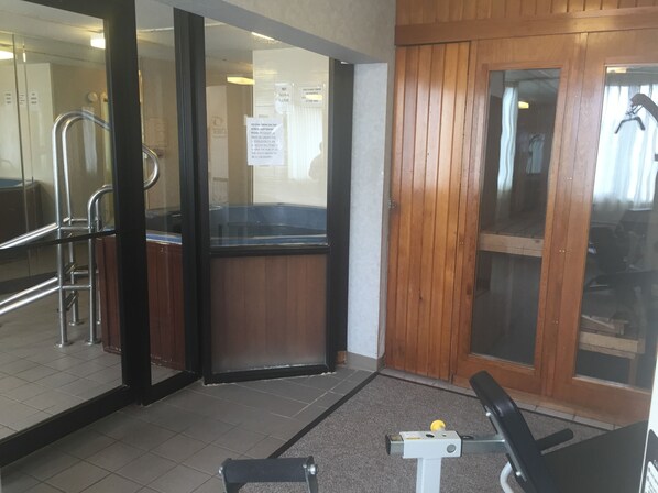 A hotel entrance with a wooden door, a glass entrance, and a metal handrail. - Fireside Inn & Suites Portland (Portland)