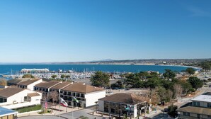 A marina with boats, a clear blue sky, and buildings with American flags.