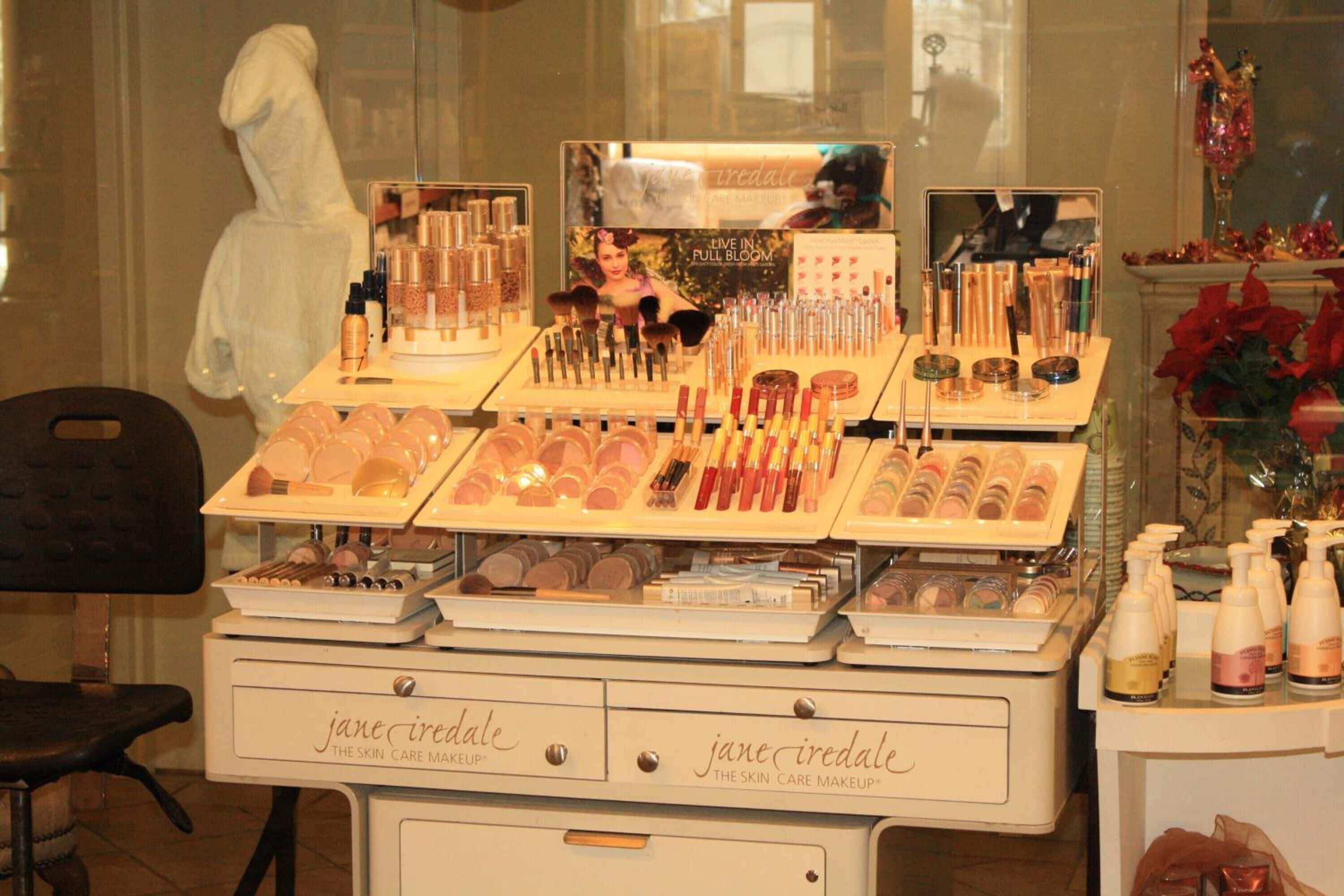 A display of various skincare and makeup products at a store named 'Jane Iredale'.