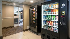 A vending machine area with various drink options and snacks.