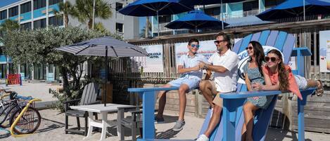 A beachside seating area with a sign reading 'TREASURE ISLAND.'