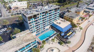 A multi-story hotel with a rooftop pool and a beachside location.