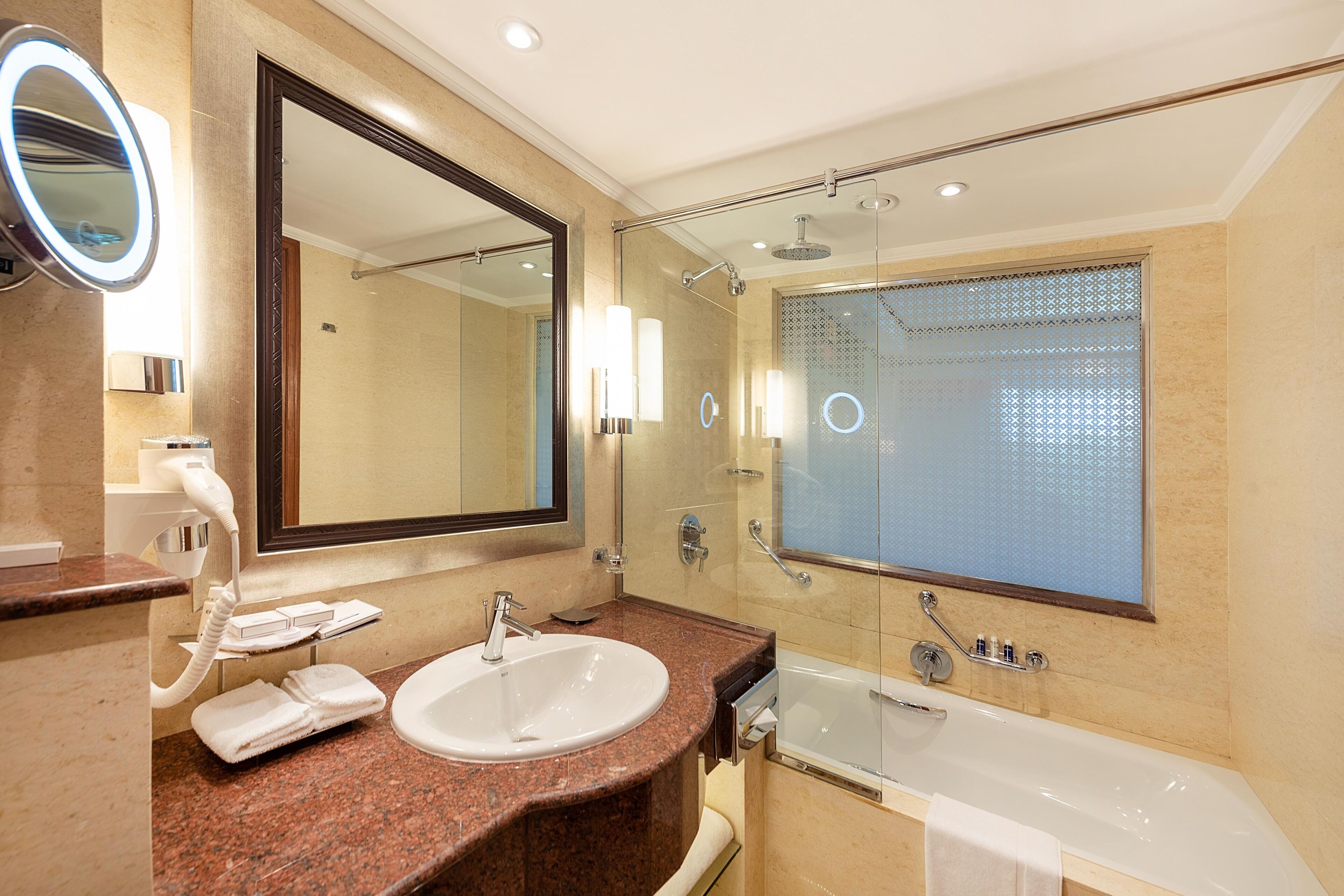Separate tub and shower, designer toiletries, hair dryer, bathrobes
