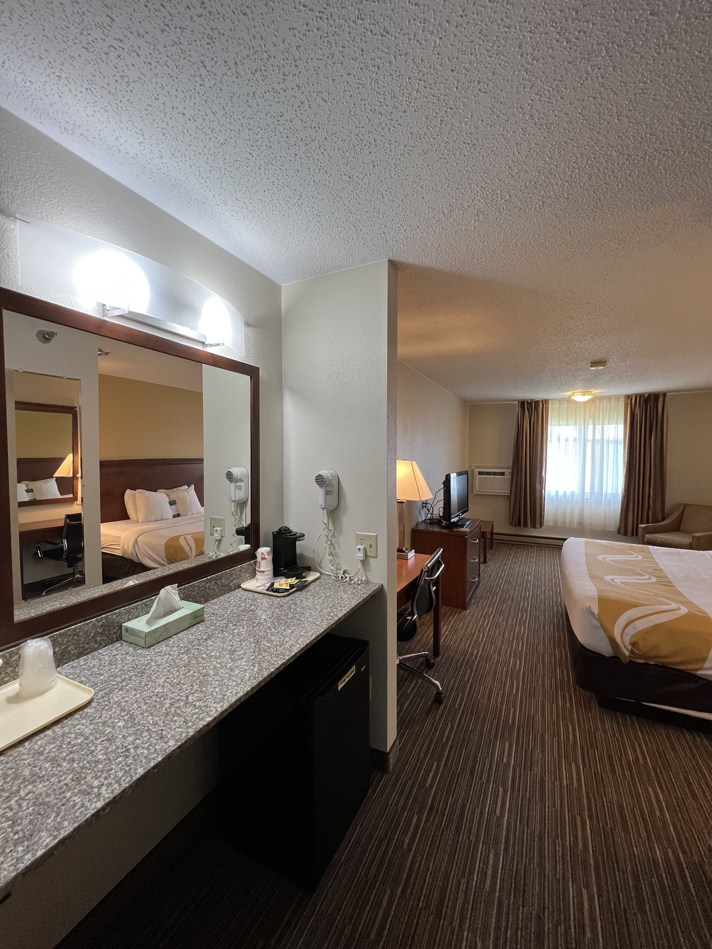 Escritorio, cortinas blackout y tabla de planchar con plancha 