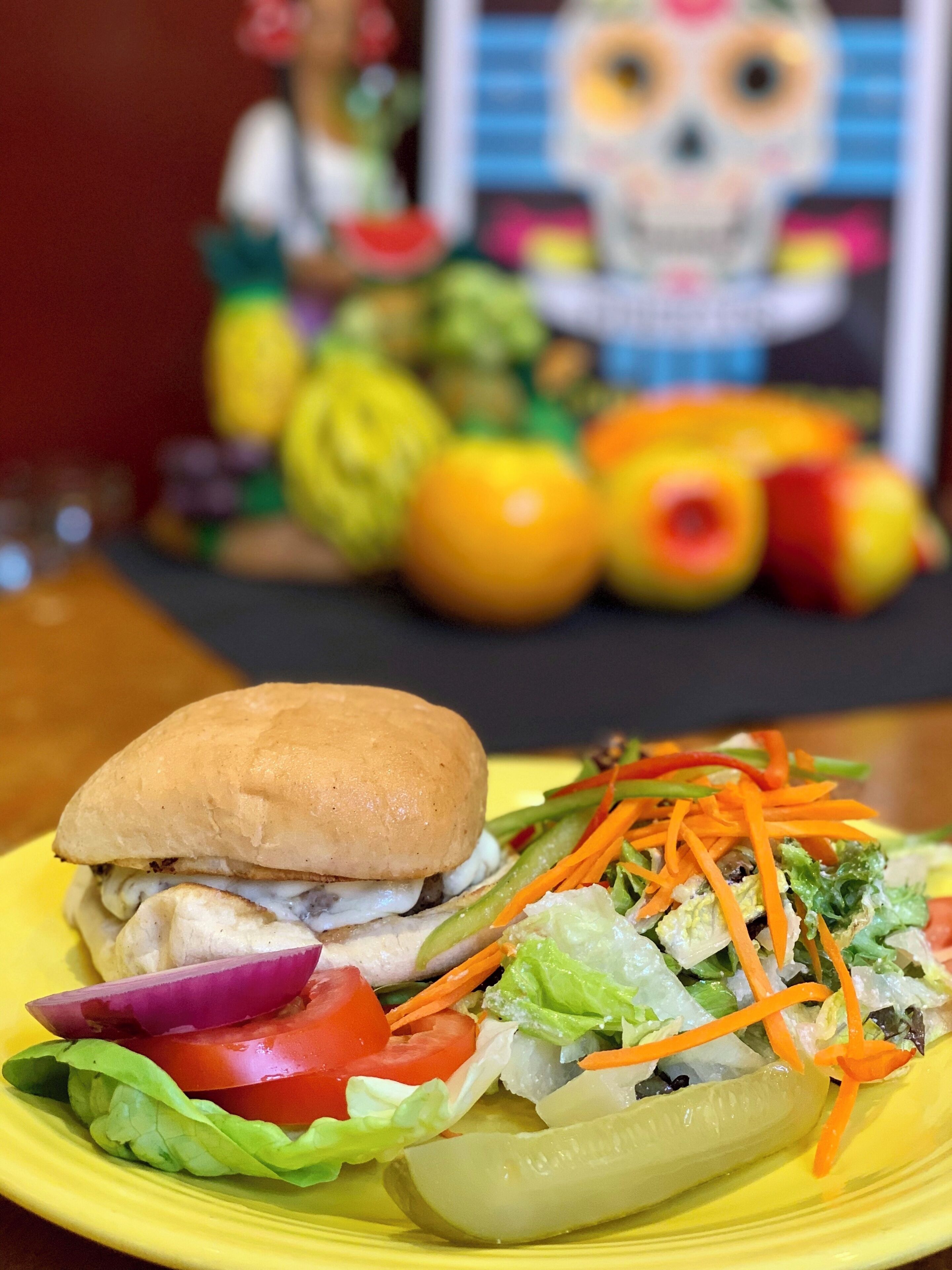 A plate with a sandwich and a salad.