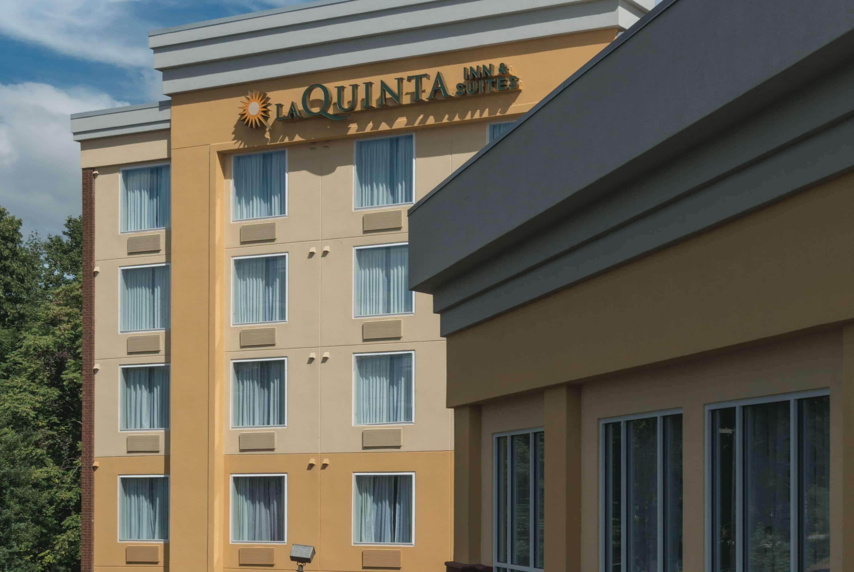 A hotel building with a sign reading "LA QUINTA INN & SUITES".
