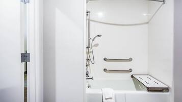 Un baño con bañera, ducha y barra para toallas.