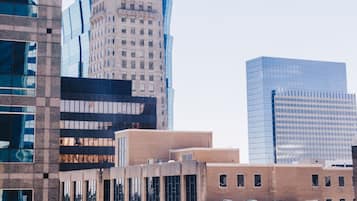 A modern cityscape with a prominent building featuring a spire and the name 'Foshay' on its facade.