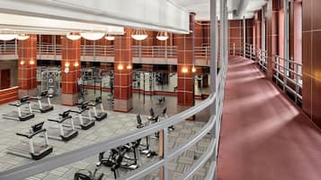 A multi-level gym with treadmills, weight machines, and exercise equipment.