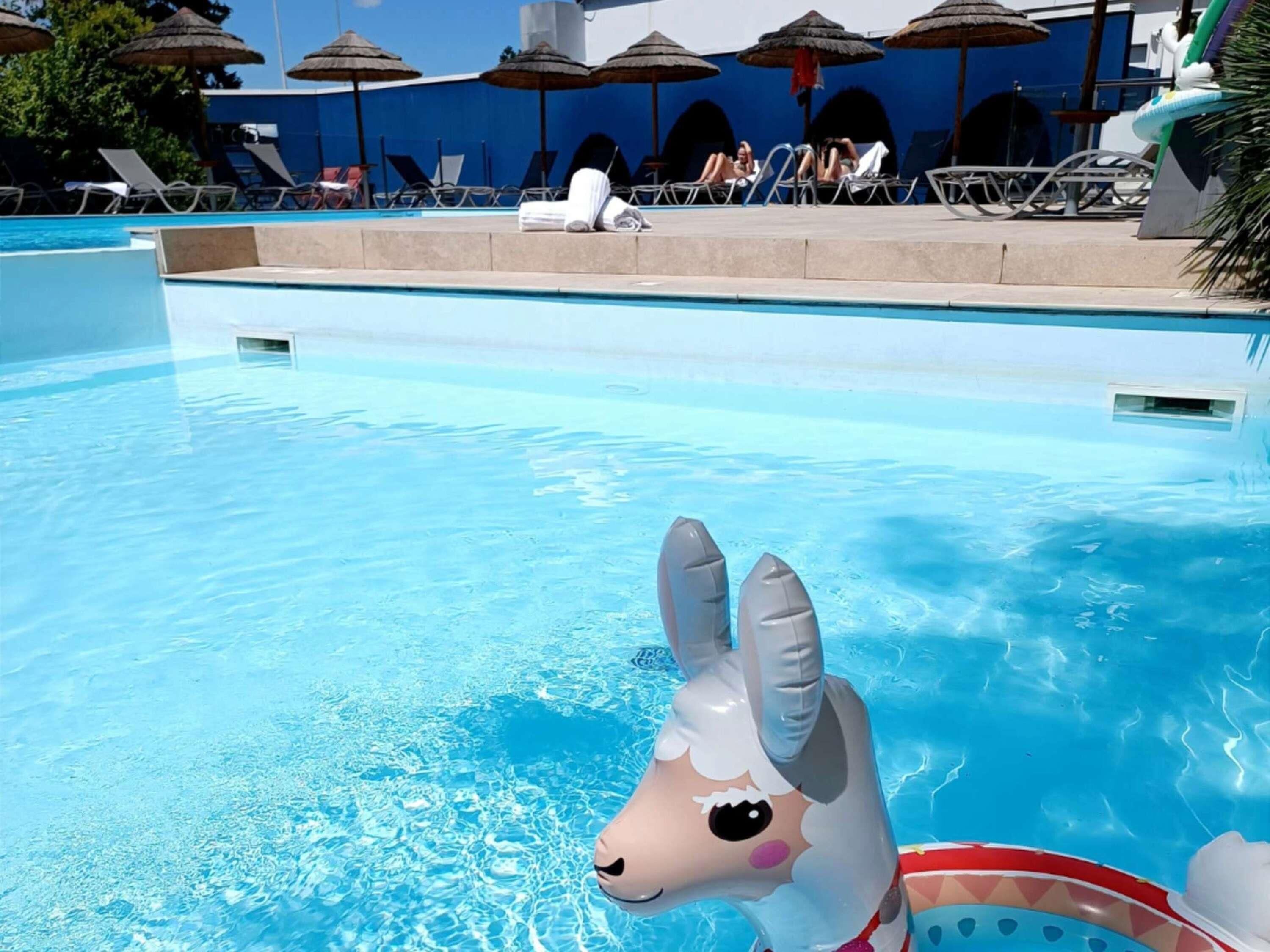 Seasonal outdoor pool, open 9:00 AM to 10:00 PM, pool umbrellas