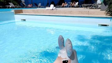 Seasonal outdoor pool, open 9:00 AM to 10:00 PM, pool umbrellas