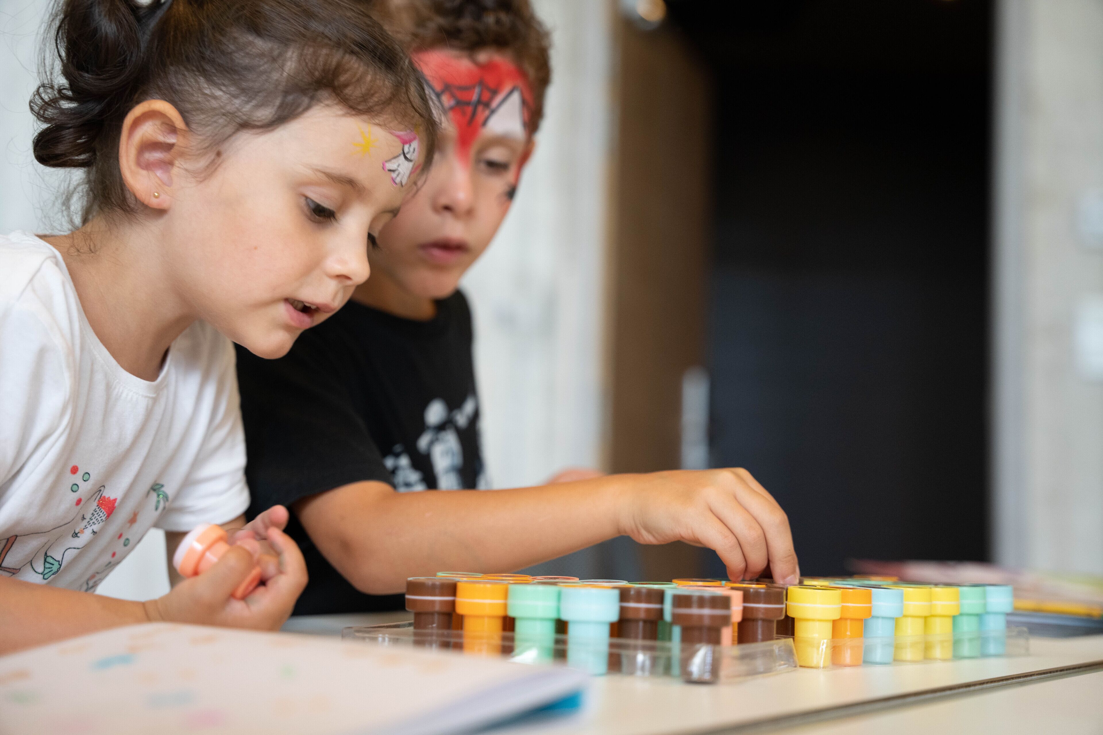 Two children playing with colorful blocks.