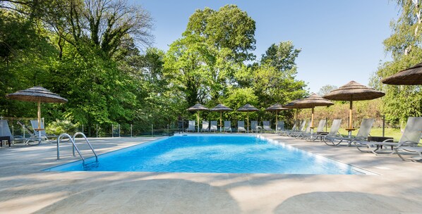 Seasonal outdoor pool, open 9:00 AM to 10:00 PM, pool umbrellas