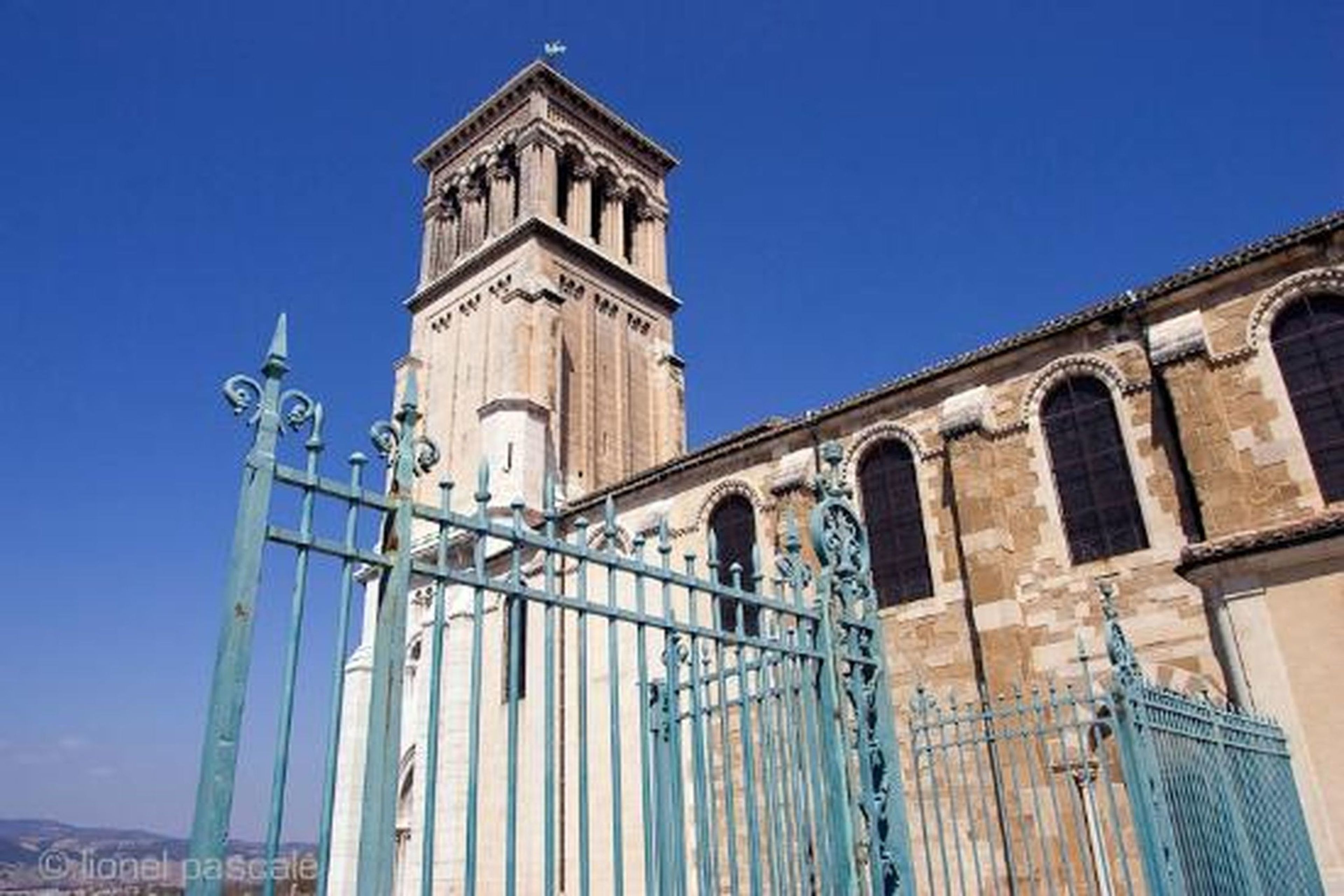 A historic building with a prominent tower and arched windows.