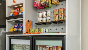 A snack and beverage section with various packaged goods and cans.