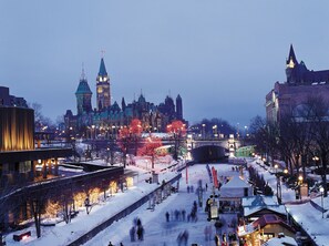 A historic cityscape with a prominent clock tower and a bridge. - Comfort Inn Ottawa East (Ottawa)