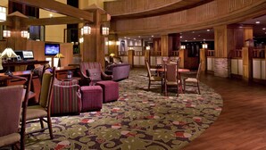 A spacious lobby with a curved wooden ceiling, comfortable seating areas, and a large flat-screen TV. - The Park Vista - a DoubleTree by Hilton Hotel - Gatlinburg (Gatlinburg)