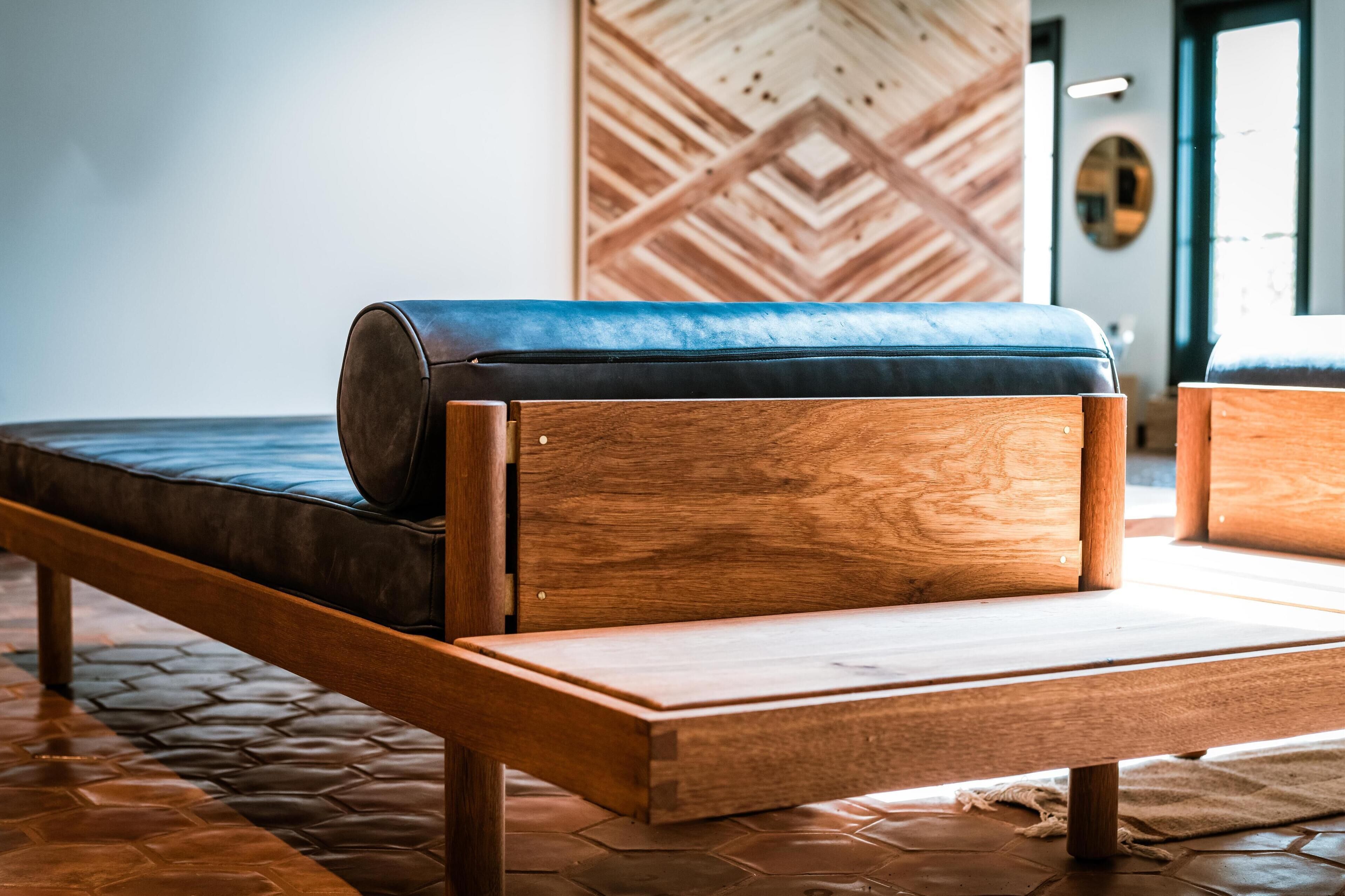 A modern room with a wooden bench and a patterned wall.