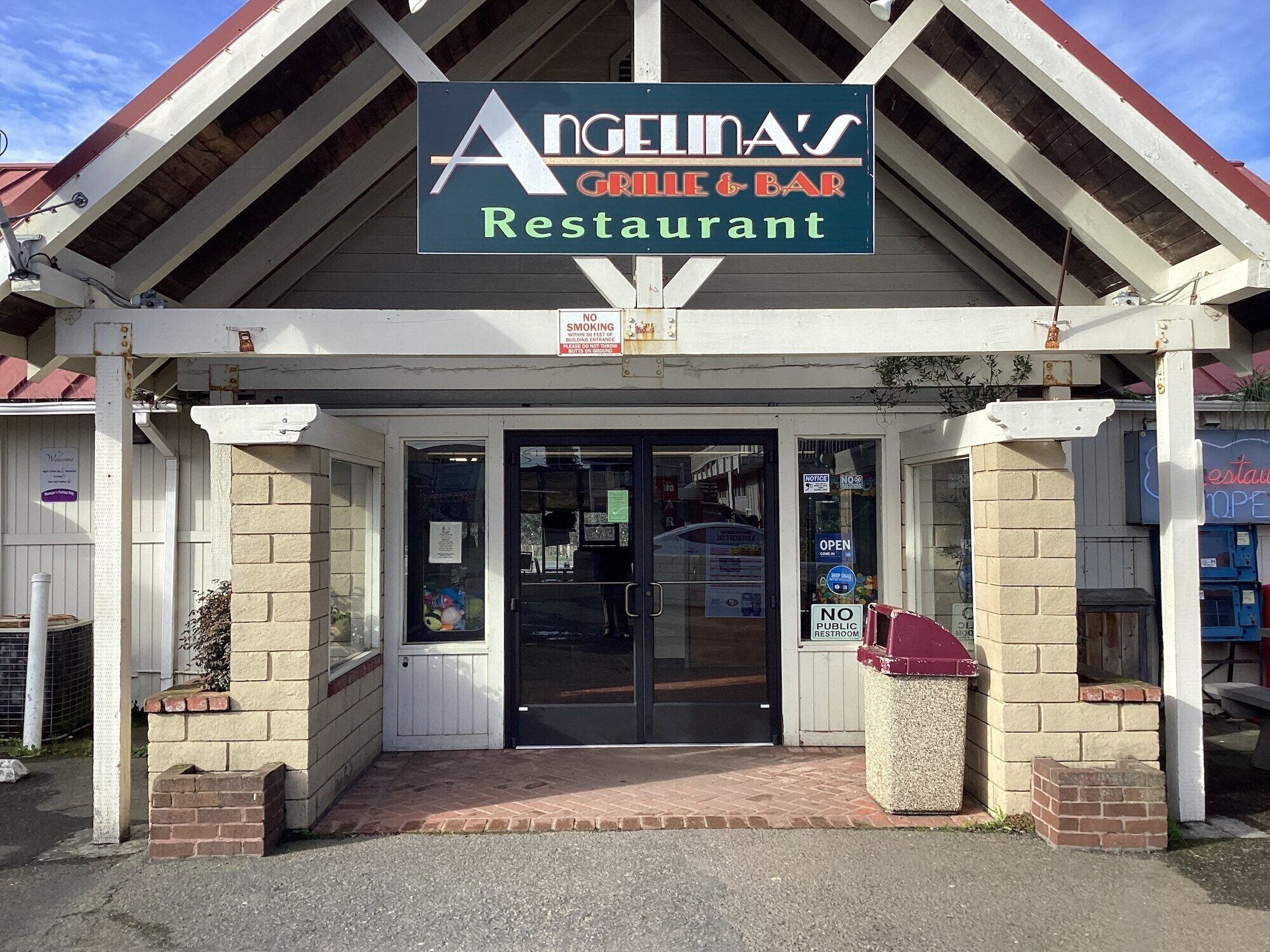 A restaurant named Angelinas Grill & Bar with a sign above the entrance.